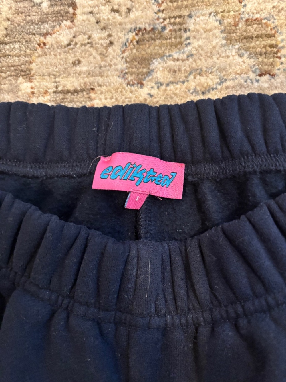 Navy blue edikted sweatpants cuffed at the bottom size small